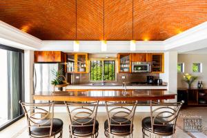 a kitchen with a large wooden table and chairs at KASA Cooper in Akumal