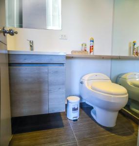 a bathroom with a toilet and a sink at Metroloft 204 in Armenia