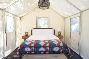a bedroom with a bed in a tent at Shaver Lake Village Hotel in Shaver Lake