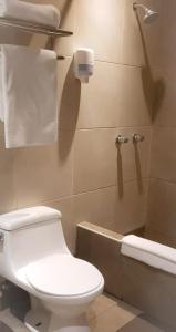 a bathroom with a toilet and a bath tub at Hostal Lince in Lima