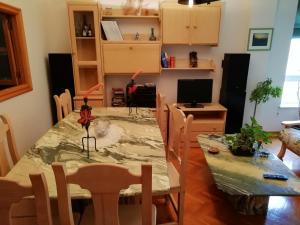 a dining room with a table and a table and chairs at Duplex Álvaro cunqueiro, 1.3C1 in Foz