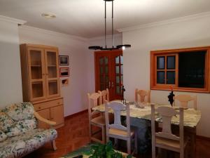 a dining room with a table and a chair at Duplex Álvaro cunqueiro, 1.3C1 in Foz