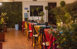 a row of tables with colorful table cloth at Hotel La Farola in Cuenca