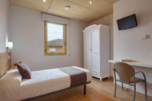 Cama o camas de una habitación en Hostal Nobadis