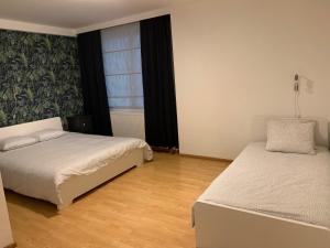 a bedroom with two beds and a window at Anna Place in Ghent