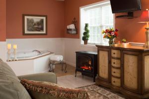 a living room with a fireplace and a bath tub at 1825 Inn Bed and Breakfast in Palmyra