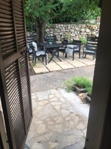 an open door to a patio with chairs and a table at Dieu L'Amour - Galimard in Châteauneuf