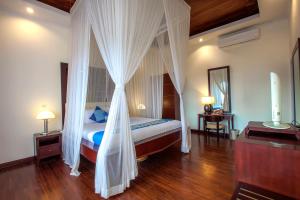 Кровать или кровати в номере The Beverly Hills Bali Villas Jimbaran
