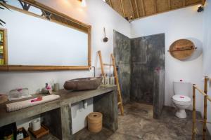 a bathroom with a sink and a toilet at Sea Breeze Villas - Gili Air in Gili Air