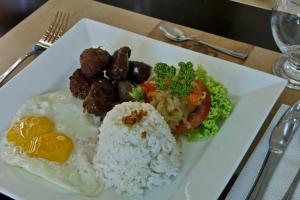 a plate of food with rice and meat and vegetables at Tagaytay Wingate Manor in Tagaytay