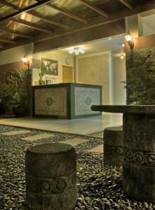 a lobby with a table and a stone floor at Tagaytay Wingate Manor in Tagaytay