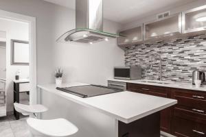 a kitchen with a counter and a stove top oven at ENTIRE 2 BEDROOM APARTMENT UPTOWN WATERLOO - e1 in Waterloo