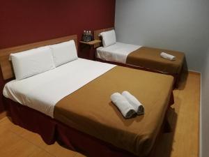 Postel nebo postele na pokoji v ubytování Grandpa Hotel