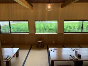 Kokuryō的住宿－無鹿リゾート，一间设有两张桌子和三扇窗户的房间