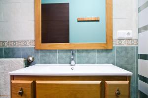 a bathroom with a sink and a mirror at Apartamentos Rurales San Xillao in Ribadeo +49 photos