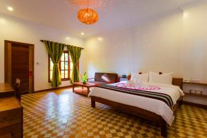 Postel nebo postele na pokoji v ubytování Le Jardin d'Angkor Hotel & Resort