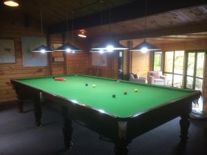 a billiard room with a pool table in a house at Westwood Lodge in Franz Josef