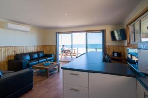 a kitchen and living room with a view of the ocean at Ceduna Shelly Beach Caravan Park in Ceduna