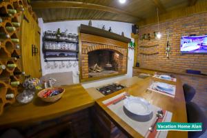 a kitchen with a fireplace and a table and a tv at Vacation home Alan 2 in Kulen Vakuf