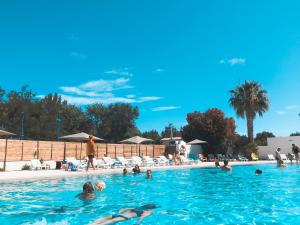 a group of people swimming in a swimming pool at Camping La Plage Argelès in Argelès-sur-Mer