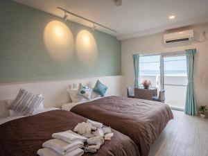 Postel nebo postele na pokoji v ubytování Yonabaru Hotel SUNRIZE OCEAN