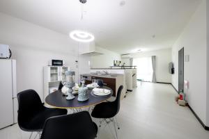 a kitchen and dining room with a table and chairs at Erable Mt.Fuji "Kaze" in Fujikawaguchiko +27 photos