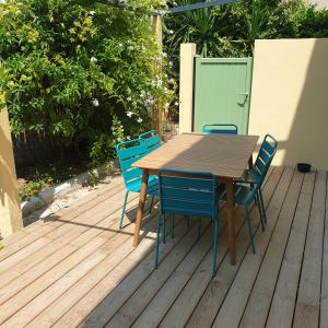 una mesa de madera y sillas en una terraza en O'Sullivans Bar and Hotel en Mandelieu-la-Napoule