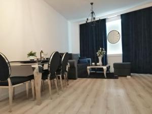 a living room with a table and chairs and a couch at Time To Relax Apartment in Zielona Góra