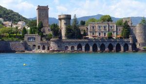 a large castle with a bridge over a body of water at O'Sullivans Bar and Hotel in Mandelieu-la-Napoule