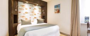 Postel nebo postele na pokoji v ubytování Hôtel Les Agapanthes-Logis Hôtel