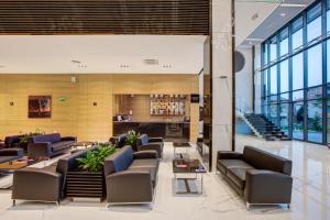 a lobby with couches and tables in a building at Merit Grand Mosta Spa Hotel & Casino in Svilengrad