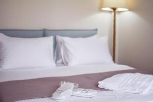 Posteľ alebo postele v izbe v ubytovaní OLIVER SUITES