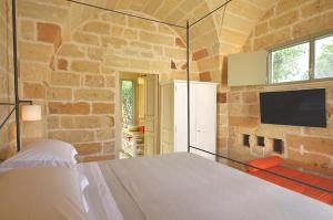 Un pat sau paturi într-o cameră la Masseria Trapana