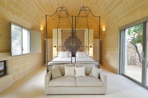 a living room with a couch and a bed at Masseria Trapana in Lecce