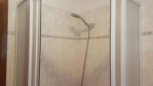 a shower with a shower head in a bathroom at Penzion Beskyd in Dolní Bečva