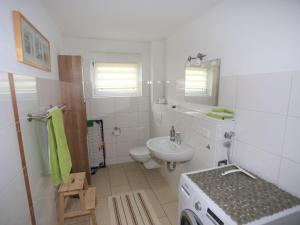 a white bathroom with a sink and a toilet at Ferienwohnung Rheingeschaut in Bad Bellingen