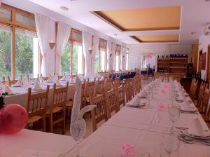 a long table in a room with tables and chairs at Hotel Fuertescusa, Serranía de Cuenca in Fuertescusa