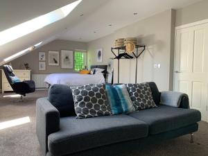 a living room with a couch and a bed at Treetops in Coleraine