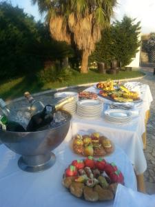 a table with plates of food and a bowl of wine at Hotel ausonia in Corigliano Calabro