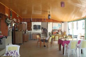 a kitchen and dining room with a table and chairs at Rose Hotel B&B in Patara