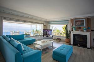 a living room with a blue couch and a fireplace at Fener Hotel Café & Kahvalti in Cesme