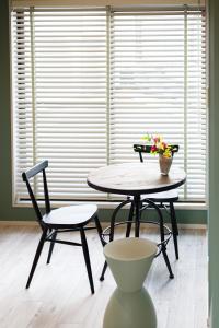 a table and a chair in a room with a window at PINO te COLO in Kanazawa