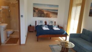 a bedroom with a blue bed and a blue couch at Villa Kapitańska in Kołobrzeg +118 photos