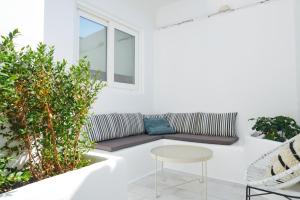 a living room with a couch and a table at Galini Hotel in Naxos Chora