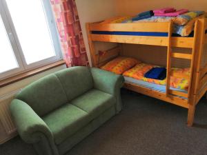 a living room with a couch and a bunk bed at Ferienhaus Hlidek in Nová Lhota +34 photos