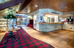 a restaurant with a table in the middle of a room at Hotel Rendezvous - Skipton - N Yorkshire in Skipton