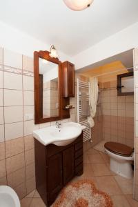 a bathroom with a sink and a toilet and a mirror at B&B Le 4 Stagioni in Nardò