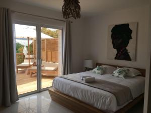 a bedroom with a bed and a sliding glass door at Villa Torrella in Mezzavia +26 photos