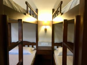 a bedroom with two bunk beds in a hostel at The KAHN Dormitory in Chikmagalūr