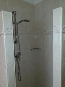 a shower with a glass door in a bathroom at Beachfront Bungalow in Torrox Costa